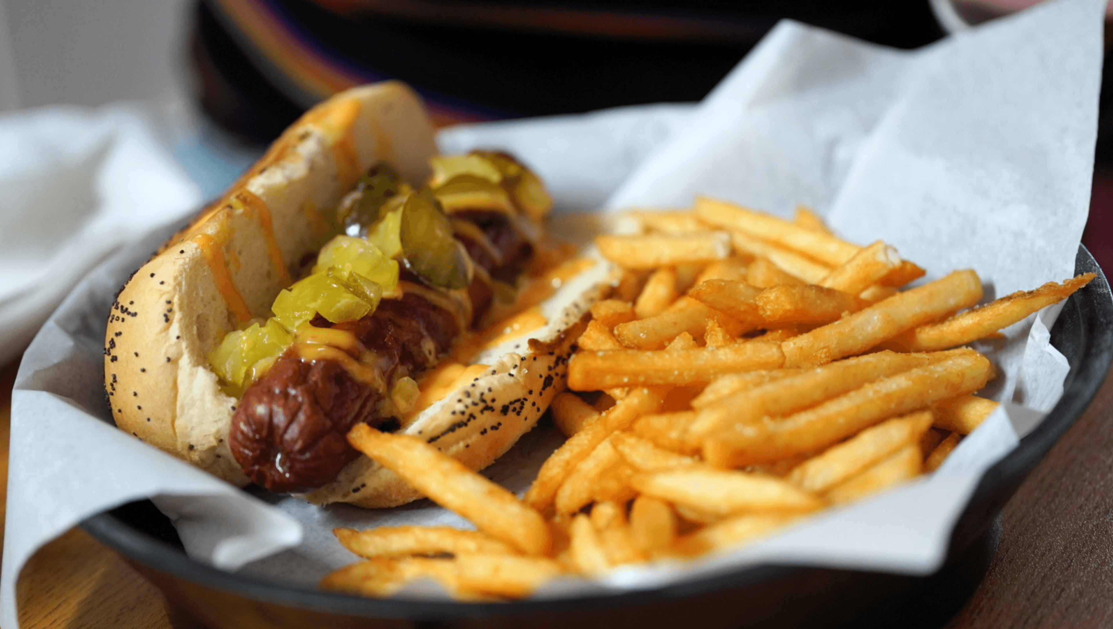 The Benedict Dog with bacon on a poppy seed bun